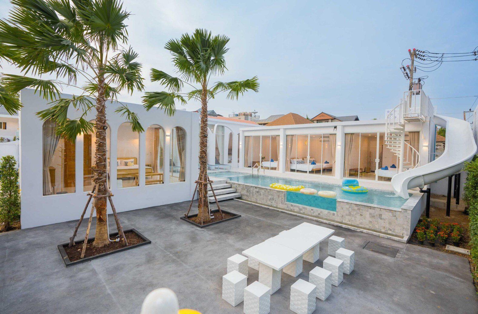 Miami Beach VI Pool Villa in Cha-Am features a large swimming pool with a fun water slide and spiral staircase.