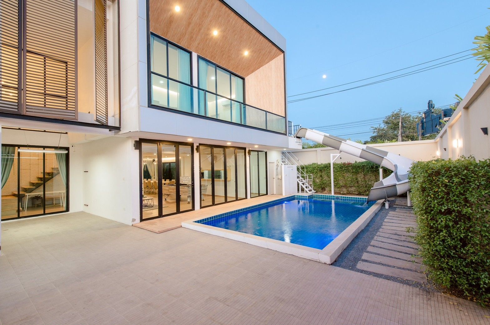 Pool with waterslide at Pool Lay AI Pool Villa, Na Jomtien, Pattaya. Modern villa with private pool.