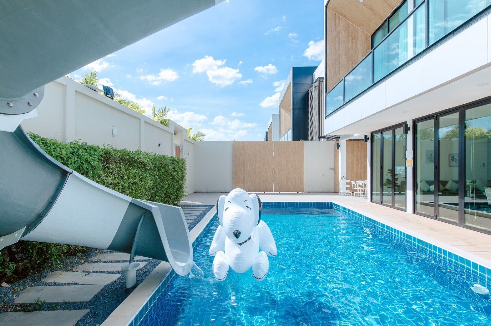 Pool with slide and Snoopy float at Pool Lay AI Pool Villa, Na Jomtien, Pattaya, Thailand.