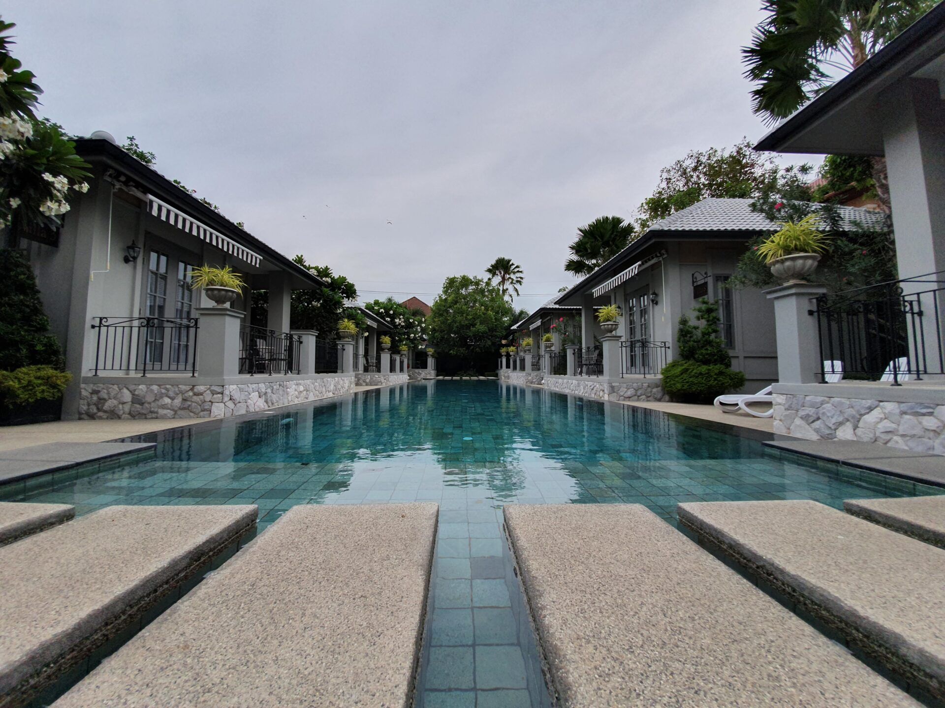 Stunning long pool at Sala Haven Nine Pool Villa, South Pattaya. Villas line the pool's edge.