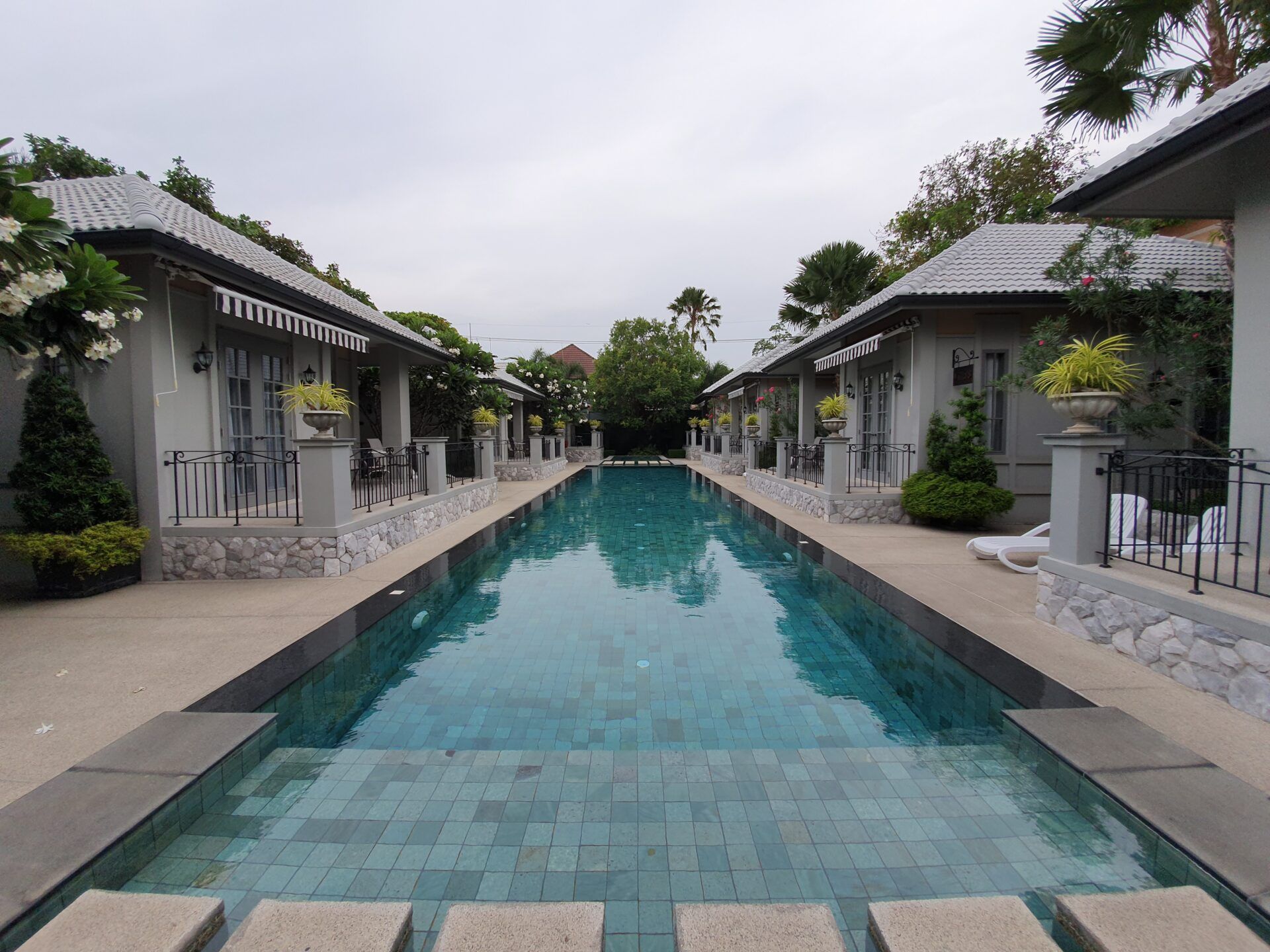 Long narrow pool between villas at Sala Haven Nine Pool Villa, South Pattaya, Thailand.