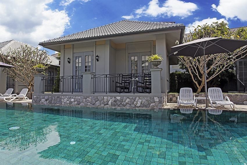Poolside villa access at Sala Haven Nine Pool Villa, South Pattaya. Relax on the deck chairs or enjoy the private balcony.