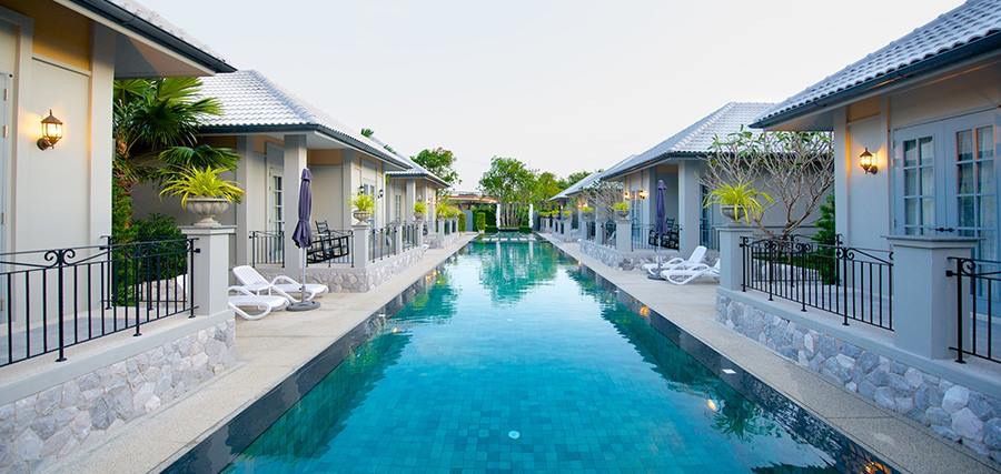 Stunning long pool view at Sala Haven Nine Pool Villa, South Pattaya. Villas line the pool for easy access.