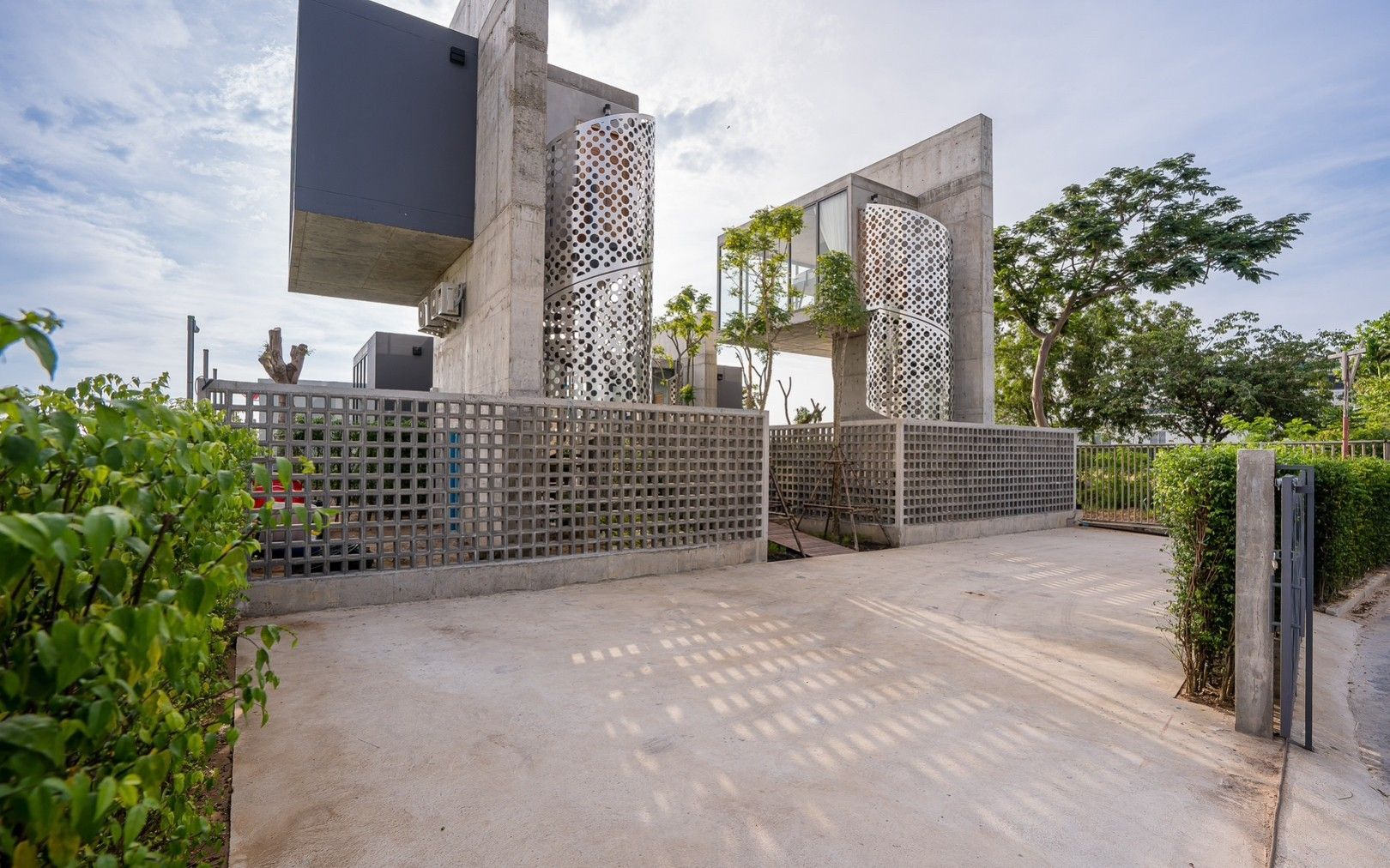Exterior view of Sea Fan IV Beachfront Pool Villa near Huahin airport, showing modern concrete design and gated entrance.