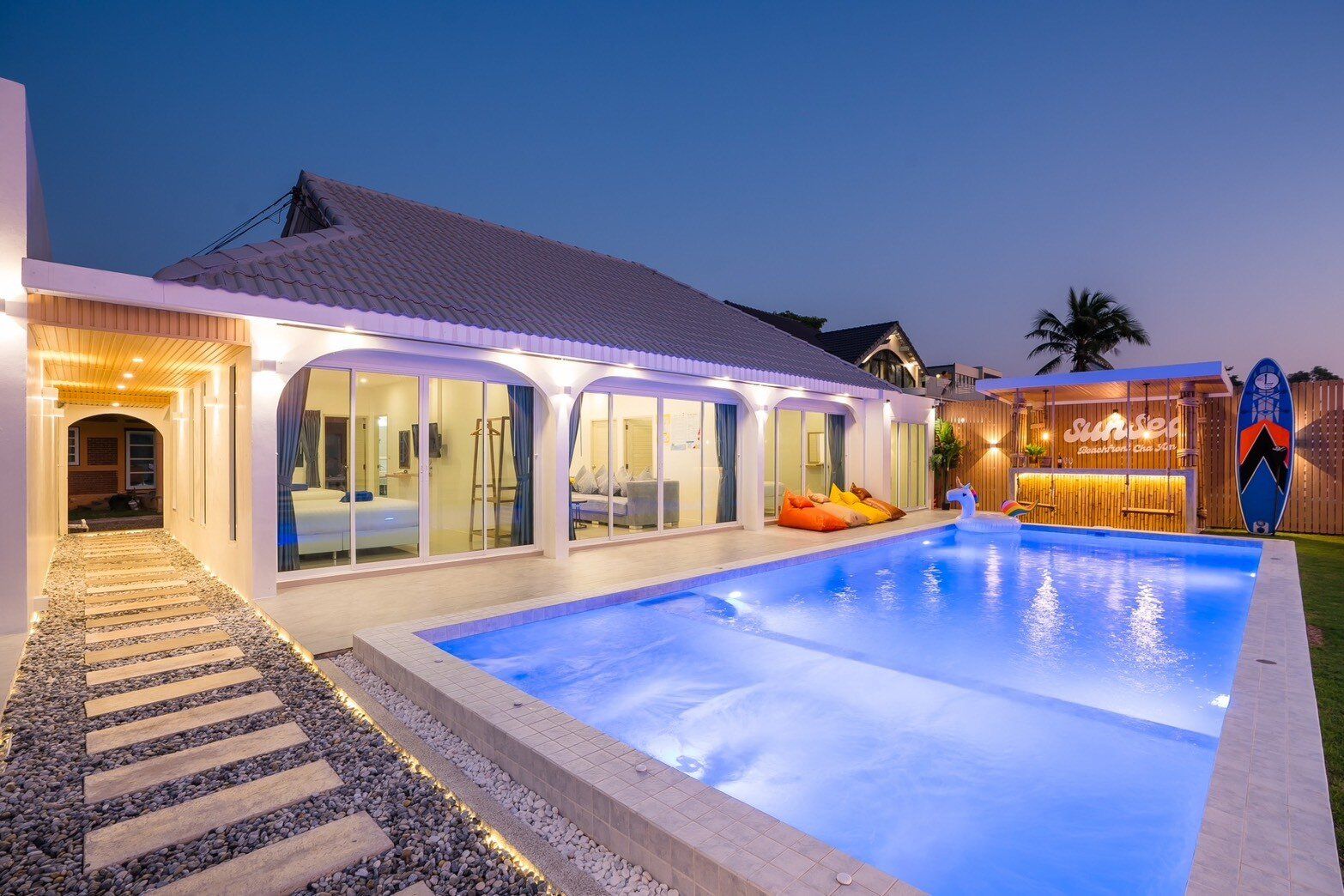 Illuminated villa and beachfront pool at Sun Sea V Pool Villa