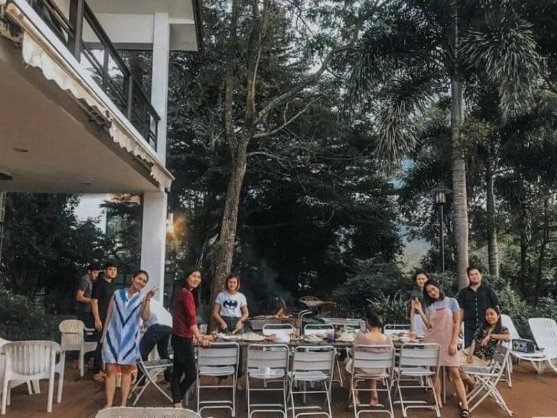 Guests enjoy an outdoor BBQ dinner on the spacious terrace at The Valley Khaoyai I, a luxury pool villa in Khao Yai.