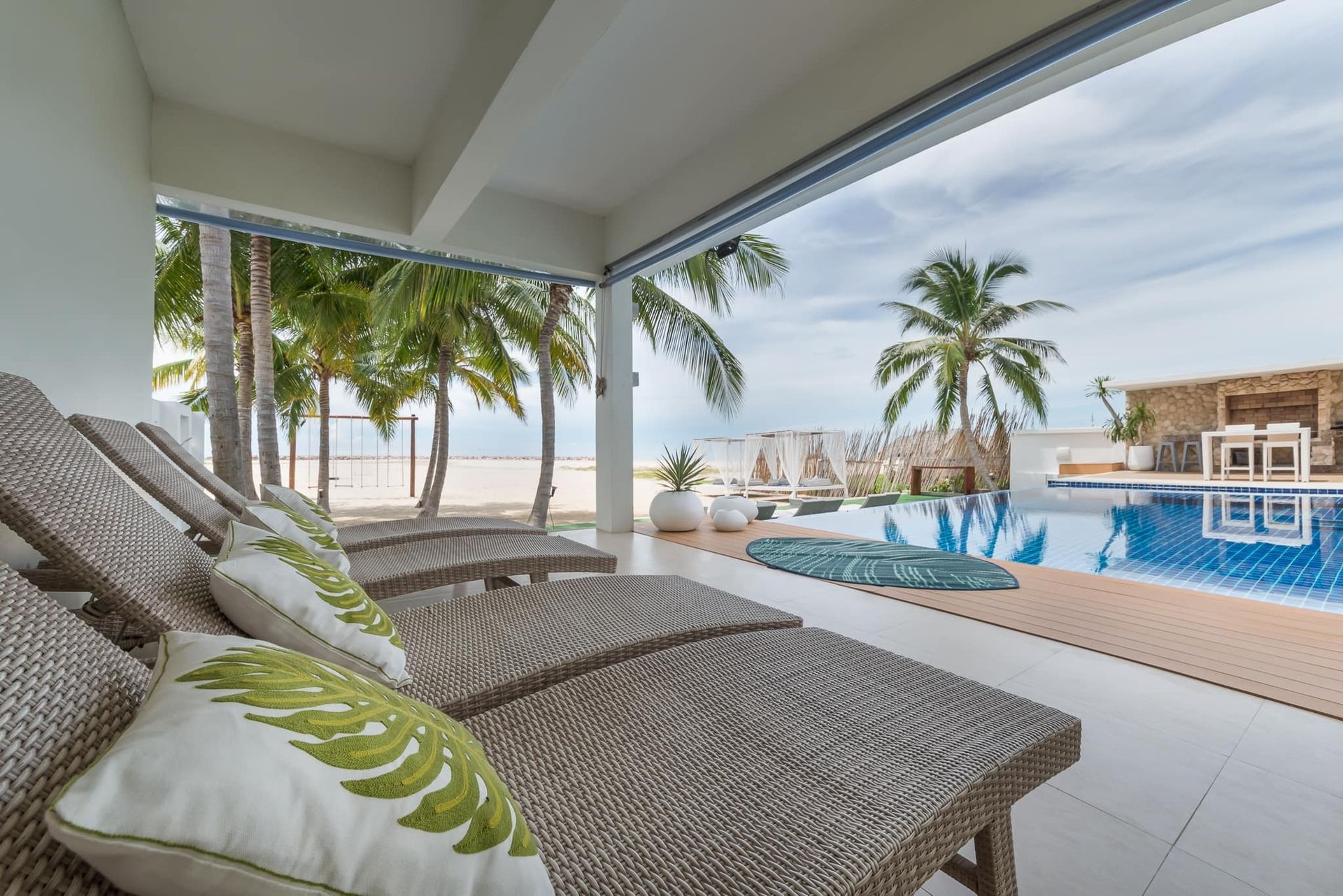 Relax by the pool at Vela VII Pool Villa, Cha-Am. Beachfront loungers and stunning views await your luxury getaway.
