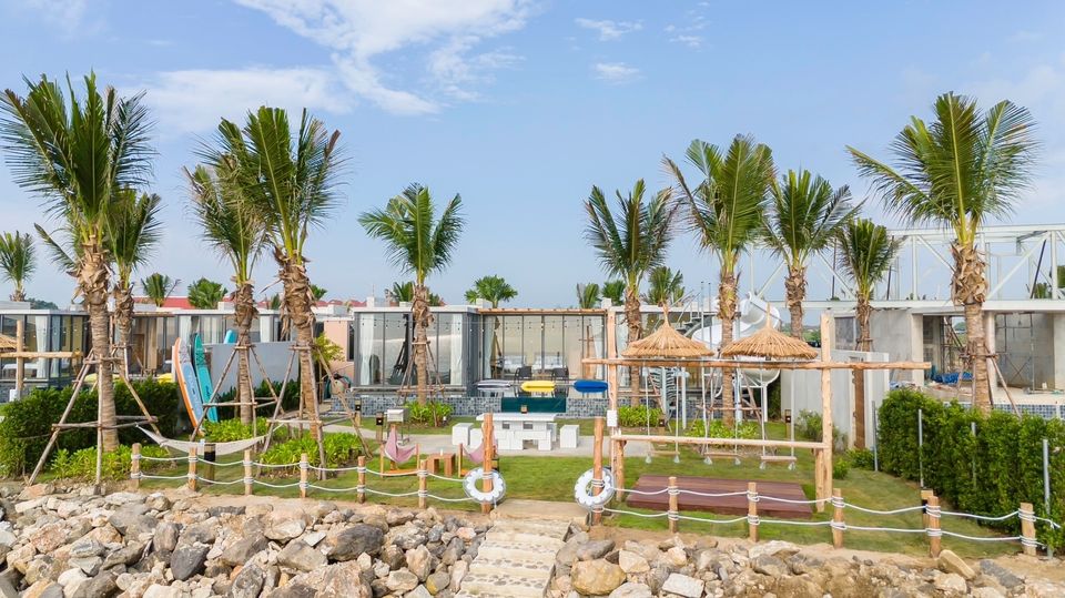 Beachfront play area at Amore' A Pool Villa, หาดปึกเตียน-ชะอำ. Features swings, hammocks, and a slide for family fun.
