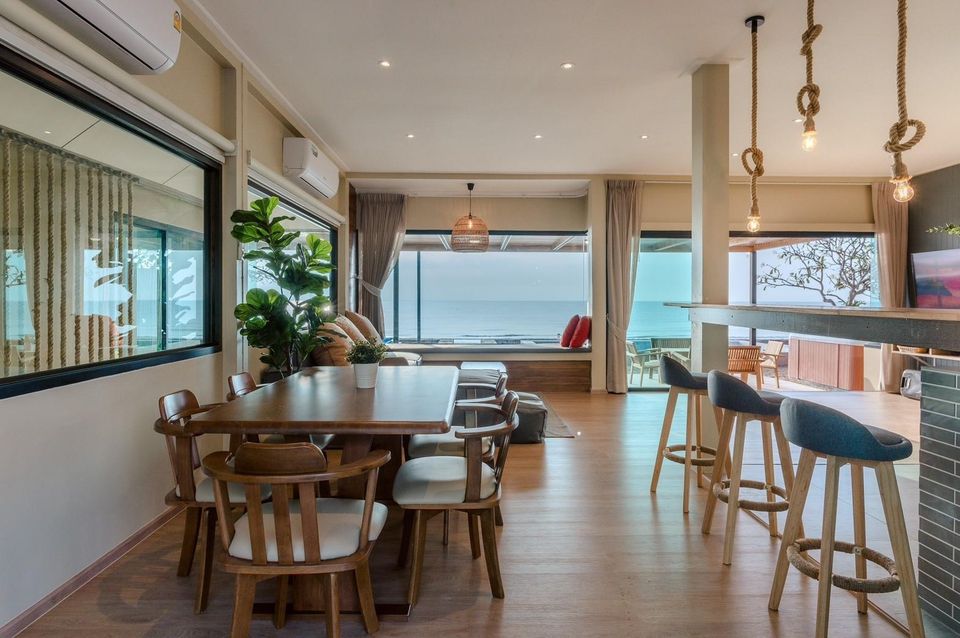 Ocean view dining area and lounge with rope pendant lights and bar — Beach Blanca IV Pool Villa
