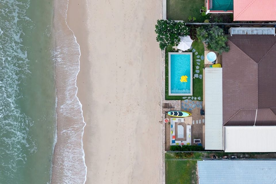 Aerial drone view of beachfront private pool villa with turquoise pool — Beach Blanca IV Pool Villa