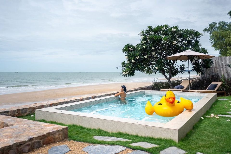 Private plunge pool with beachfront sun loungers, frangipani tree and ocean view — Beach Blanca IV Pool Villa