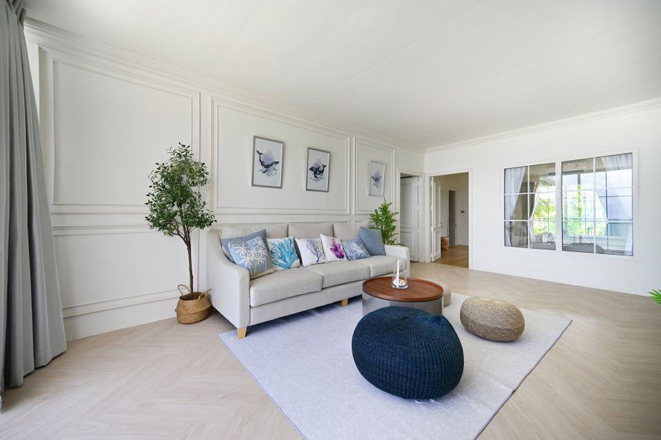 Bright living room at Coastal Calm IV Pool Villa, Cha-Am, featuring a comfortable sofa with coastal-themed pillows and a rou