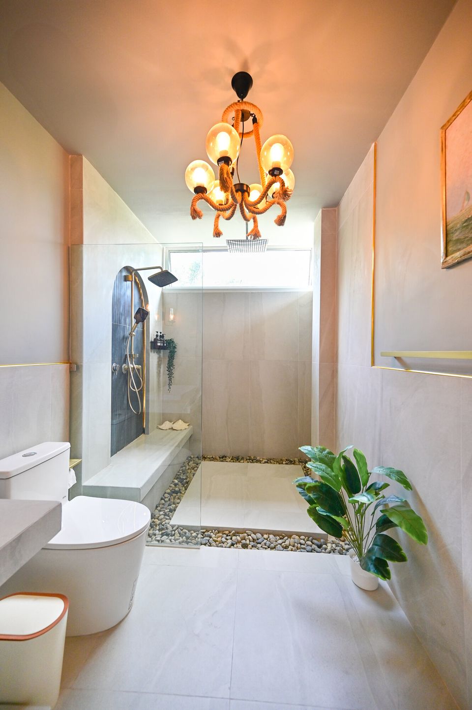 Modern bathroom at Coastal Calm IV Pool Villa, Cha-Am, featuring a spacious walk-in shower with pebble floor and unique chan