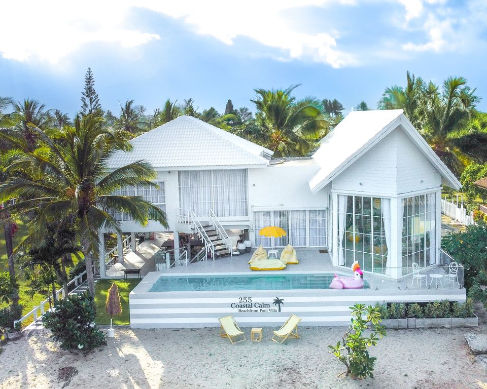 Aerial view of Coastal Calm IV Pool Villa in Cha-Am, showing the white beachfront villa, pool, and sandy area.