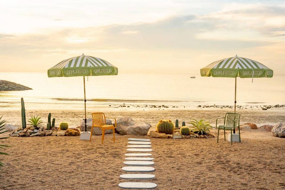 Beachfront seating area with umbrellas at Darlington IV Pool Villa. Relax by the sea in style.