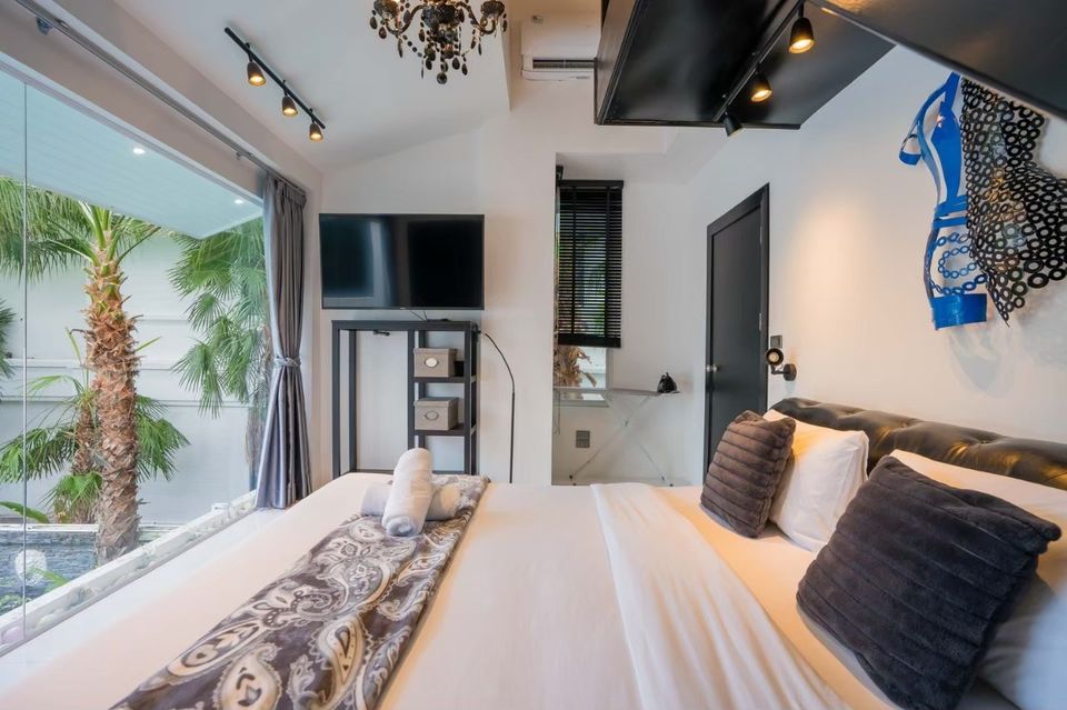 Bedroom with mezzanine sleeping area at Emerald VII Pool Villa