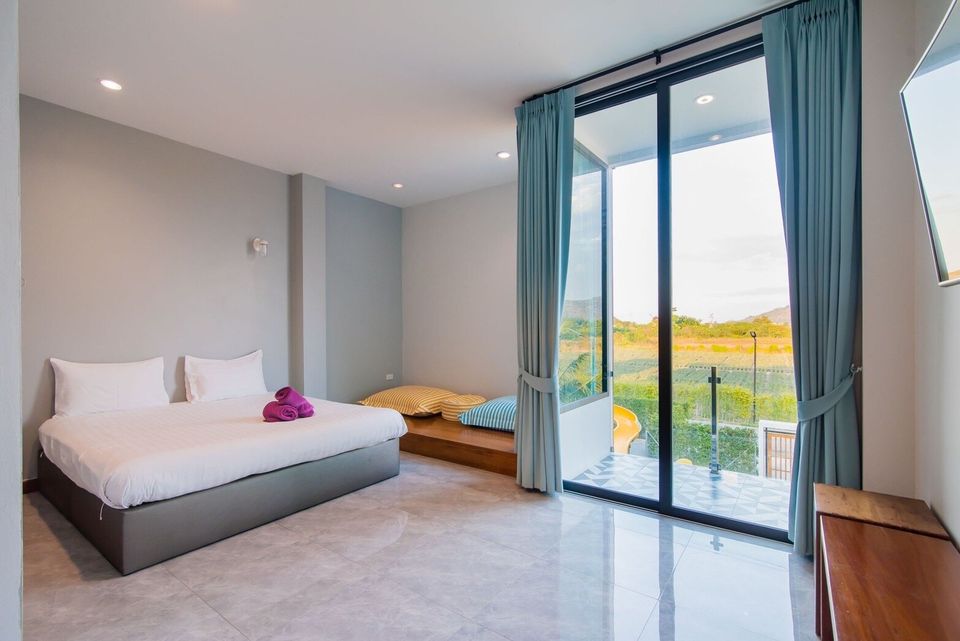 Bedroom with king bed and balcony at Exclusive Proud VII Villa in Hua Hin