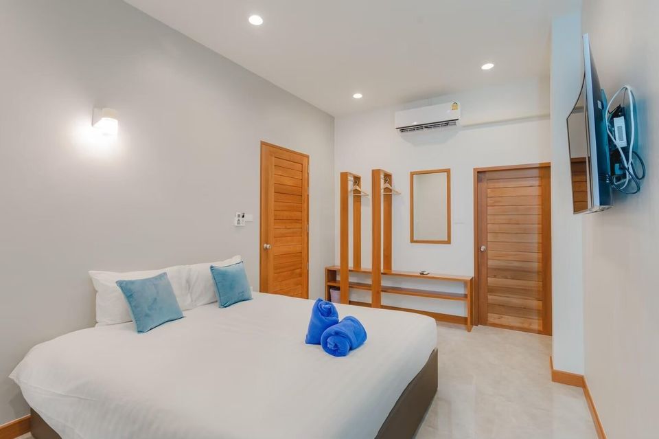Bedroom with king bed and TV at Exclusive Proud VII Villa in Hua Hin