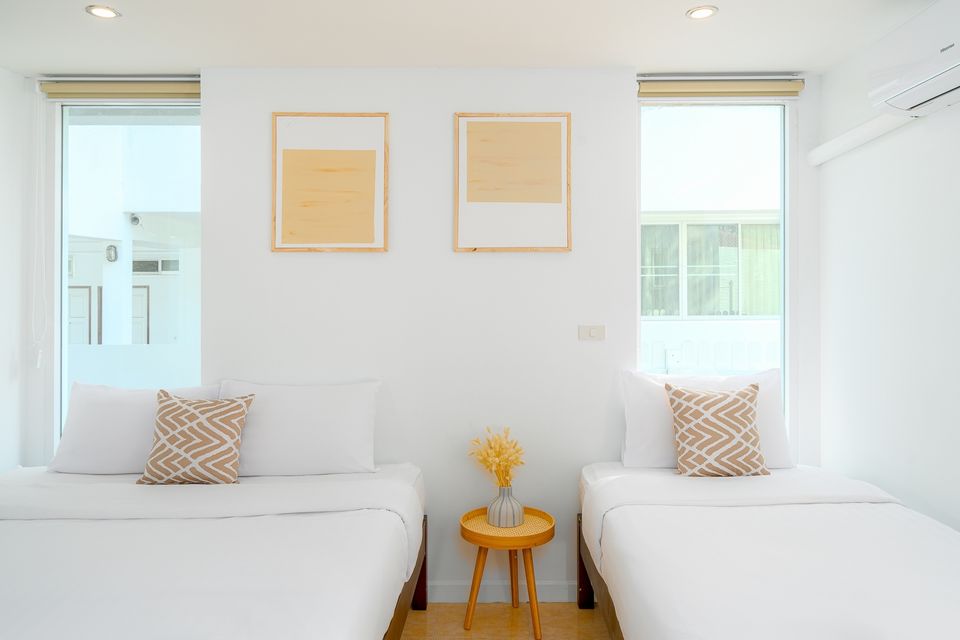 Twin bedroom at G Villa III Pool Villa, Pak Nam Pran. Two beds with white linens and modern artwork.