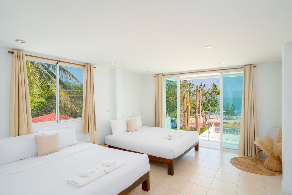 Bright bedroom with twin beds and beach view at G Villa III Pool Villa, Pak Nam Pran, Pranburi.