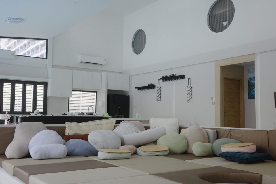 Unique modular sofa with decorative pillows in the living room of Glass Beach III Pool Villa, หาดดงตาล พัทยาใต้.