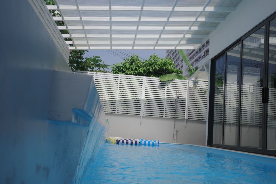 Waterfall feature and colorful inflatables in the pool at Glass Beach III Pool Villa, South Pattaya.