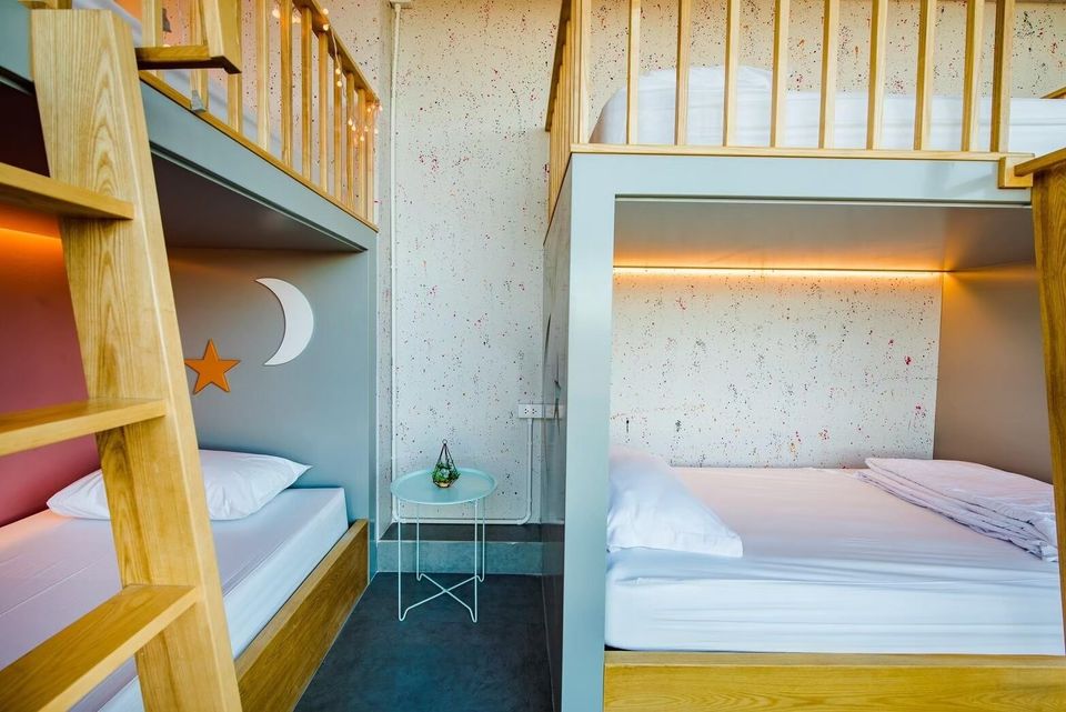 Modern bunk beds with wooden ladders and soft lighting in a bedroom at Holiday Sunset Villa IV, Hua Hin.