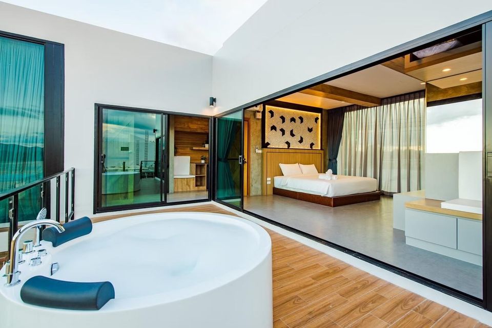 Indoor jacuzzi tub with a view into a modern bedroom at Holiday Sunset Villa IV in Hua Hin, Thailand.