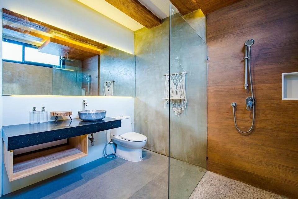 Modern bathroom with a walk-in shower, floating vanity, and large mirror at Holiday Sunset Villa IV, Hua Hin.
