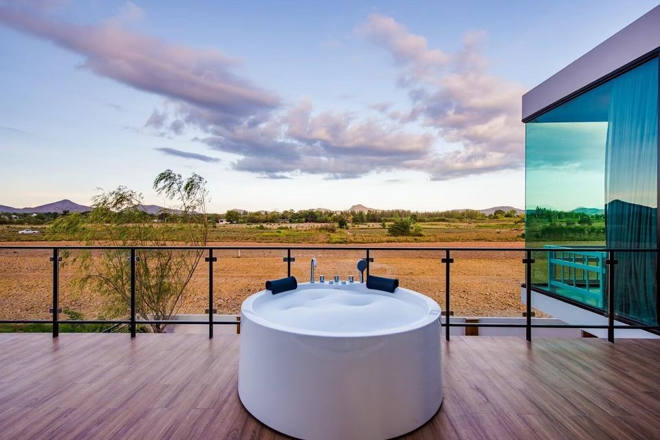 Outdoor jacuzzi on a private balcony at Holiday Sunset Villa IV in Hua Hin, offering stunning views of the surrounding landscape.