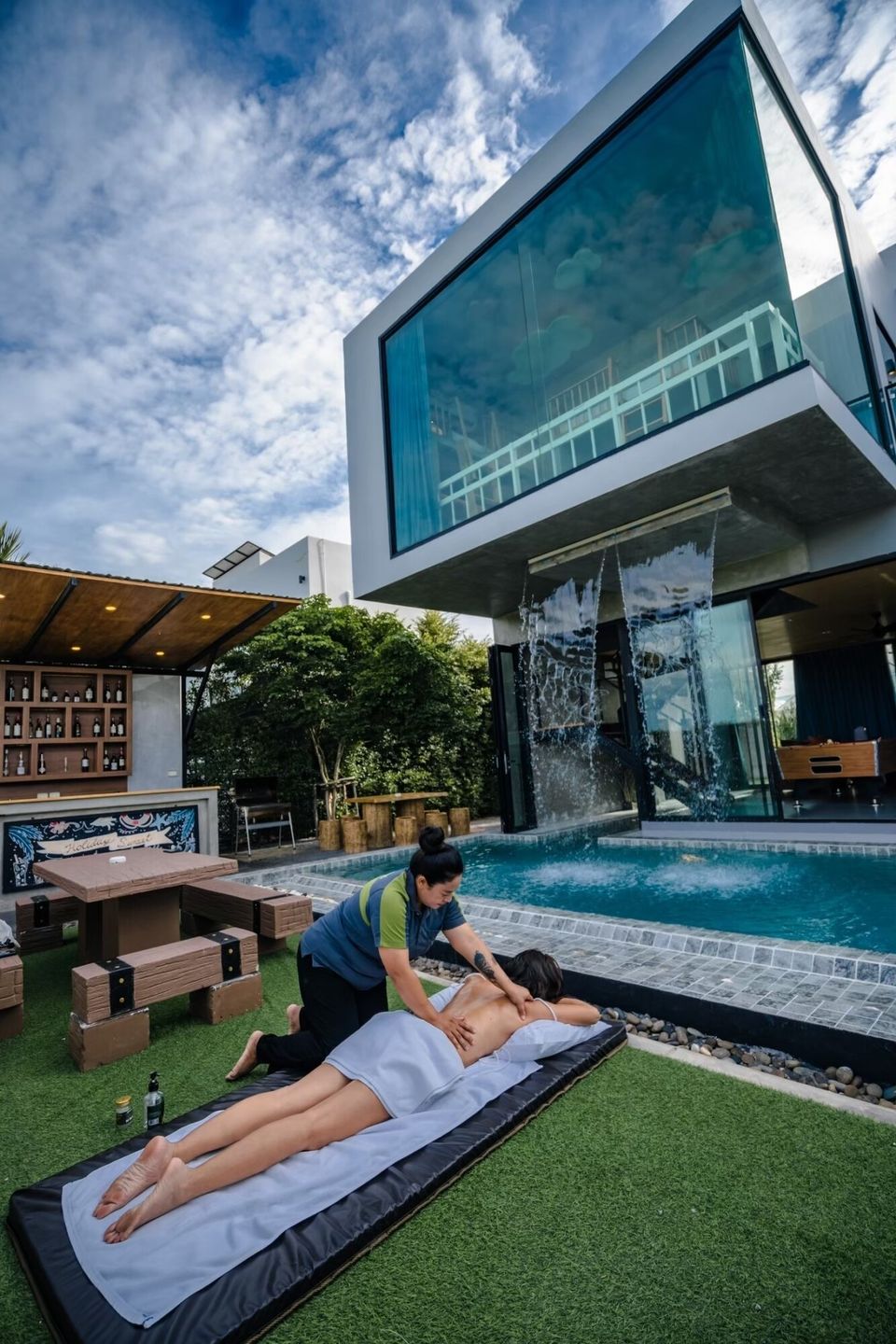 Enjoy a relaxing outdoor massage by the pool with a stunning waterfall feature at Holiday Sunset Villa IV, Hua Hin.