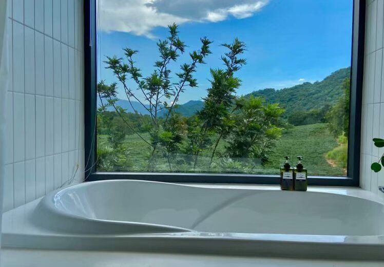 Relax in the modern bathtub with stunning mountain and greenery views at Kin Khaoyai V Pool Villa, Khao Yai.