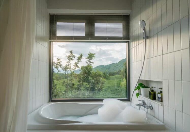 Relax in a bubble bath with stunning mountain views from Kin Khaoyai V Pool Villa, Khao Yai. Perfect for a serene escape.