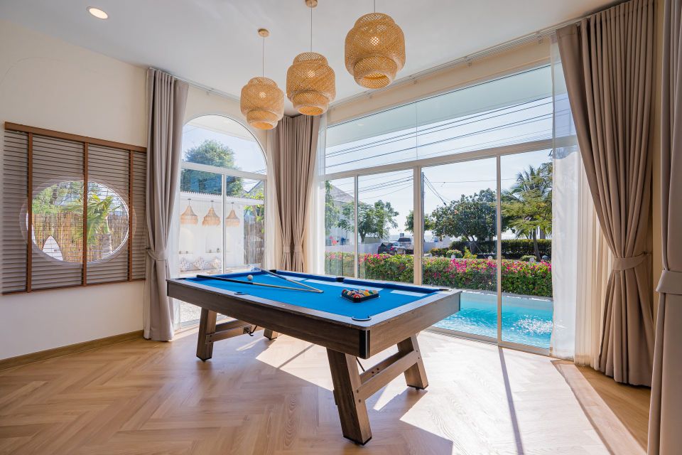 Indoor pool table at Lagoon Beach V Pool Villa, near Bang Kao Beach, Cha-am. View of the pool and garden.