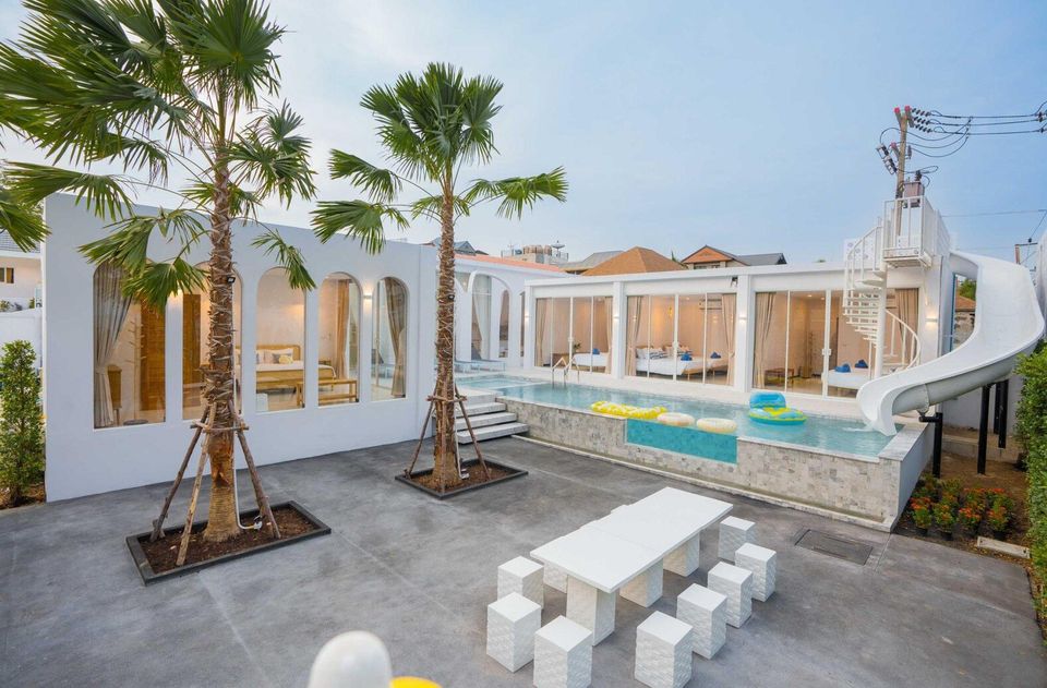 Miami Beach VI Pool Villa in Cha-Am features a large swimming pool with a fun water slide and spiral staircase.