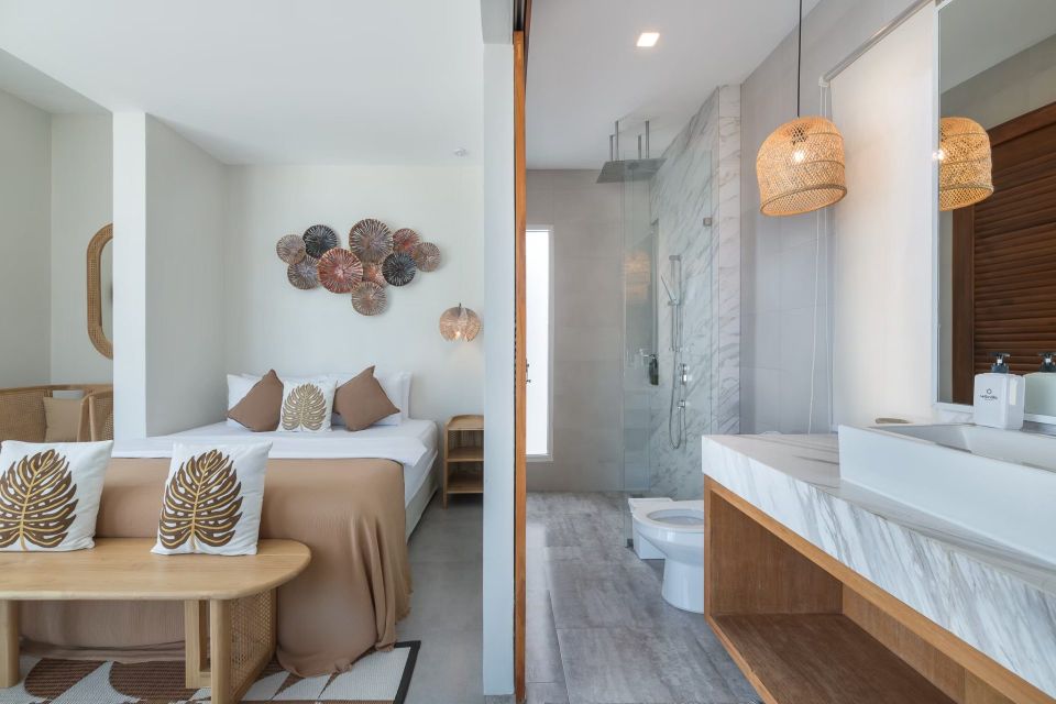 Vela VI Pool Villa bedroom and bathroom suite in หาดปึกเตียน ชะอำ. Features a king bed, walk-in shower, and modern design.