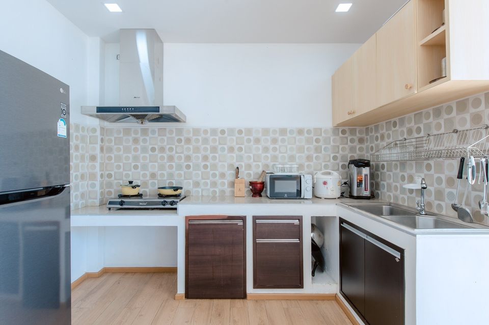 Modern kitchen with appliances at Pool Lay AI Pool Villa, Na Jomtien, Pattaya, Thailand.
