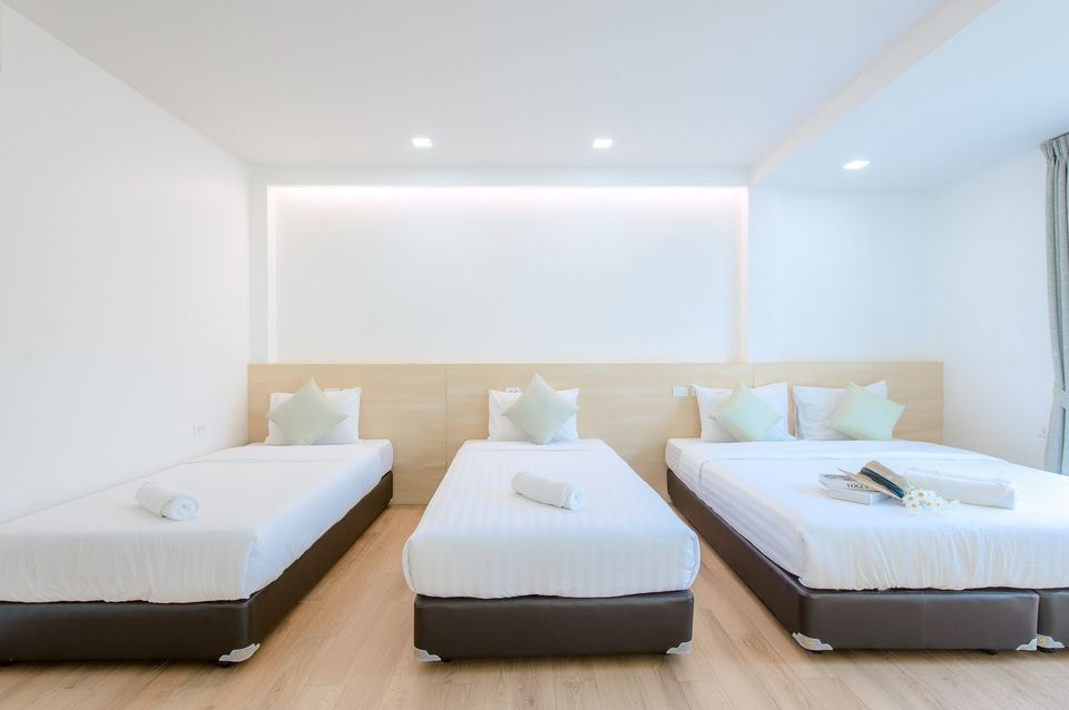 Bright bedroom with three single beds at Pool Lay AI Pool Villa, Na Jomtien, Pattaya, Thailand.