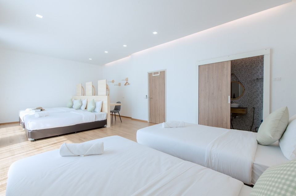 Bright bedroom with three beds at Pool Lay AI Pool Villa, Na Jomtien, Pattaya, Thailand.