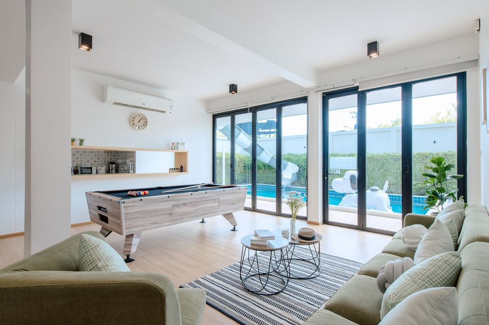 Bright living room with pool table and pool view at Pool Lay AI Pool Villa, Na Jomtien, Pattaya.