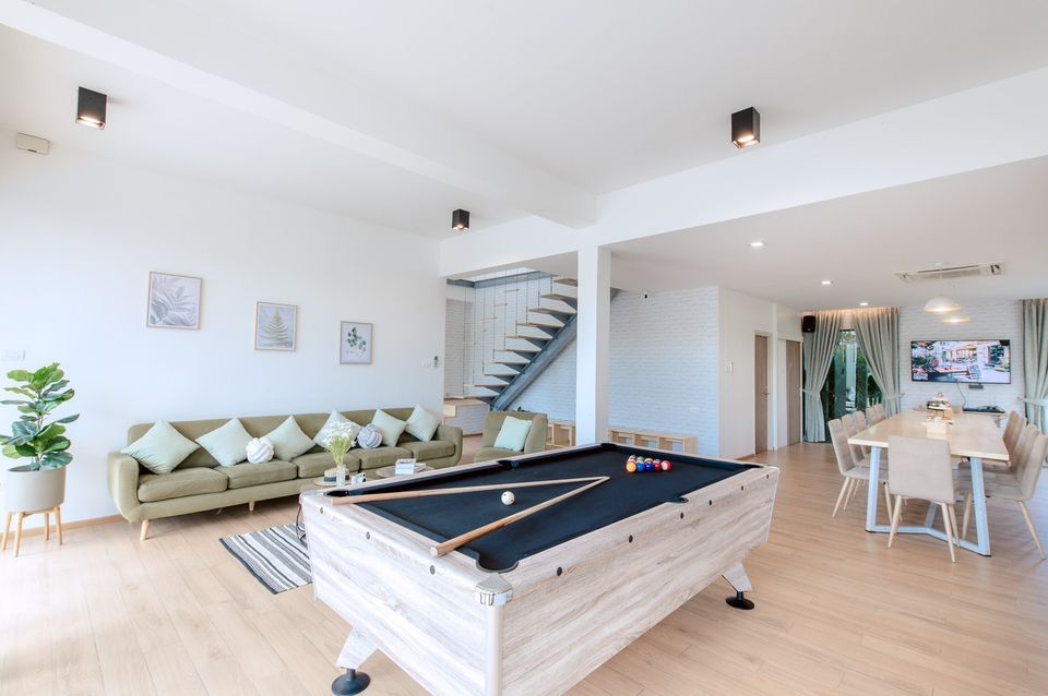 Open-concept living space with billiards, dining, and lounge at Pool Lay AI Pool Villa, Na Jomtien, Pattaya.