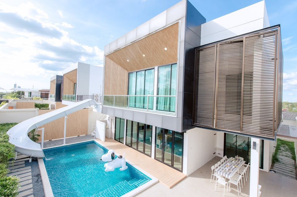 Pool Lay AII Pool Villa in Na Jomtien, Pattaya, features a private pool with a waterslide and dog float.