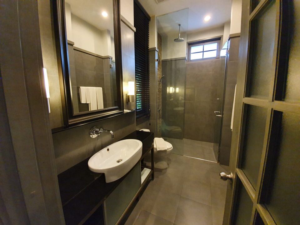 Modern bathroom with walk-in shower at Sala Haven Nine Pool Villa, South Pattaya, Thailand.