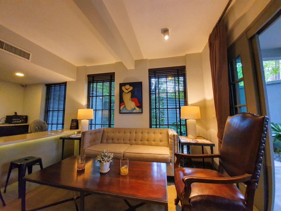 Comfortable living room at Sala Haven Nine Pool Villa, South Pattaya. Sofa, coffee table, and natural light from the windows.