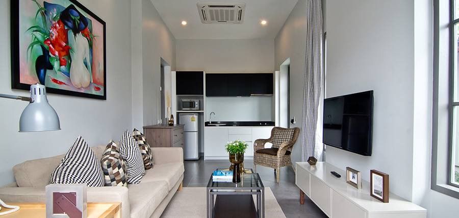 Living area with open kitchen at Sala Haven Nine Pool Villa, South Pattaya. Modern design, comfortable seating.
