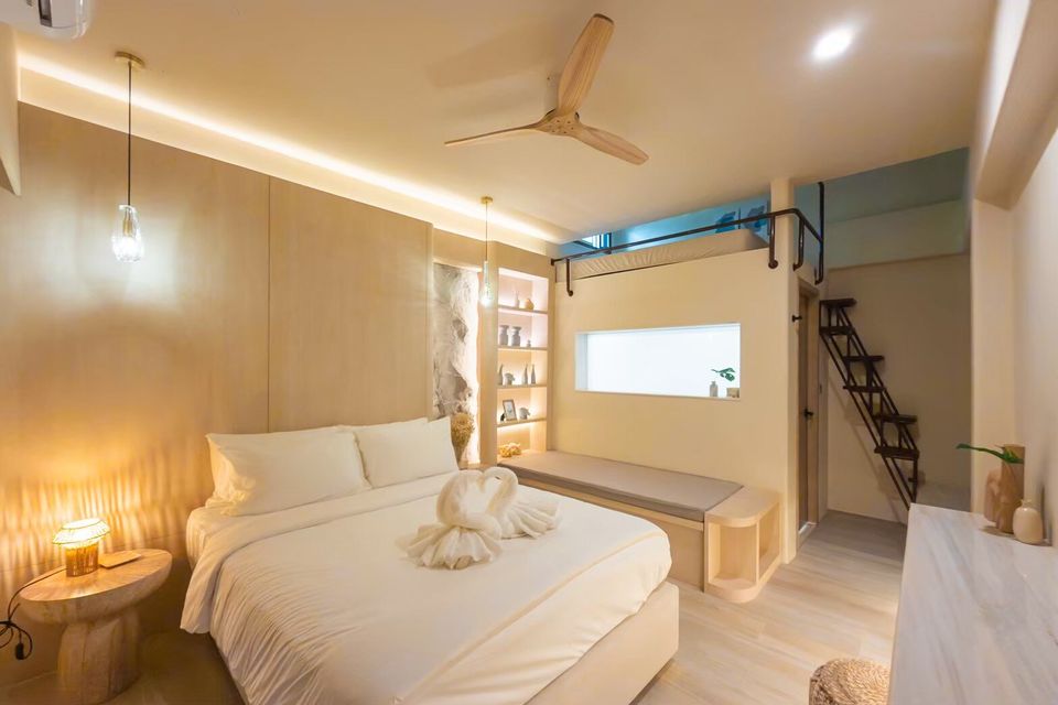 Modern bedroom at Sand Moment VI Pool Villa, Rayong, featuring a comfortable bed, a loft bunk, and stylish lighting.