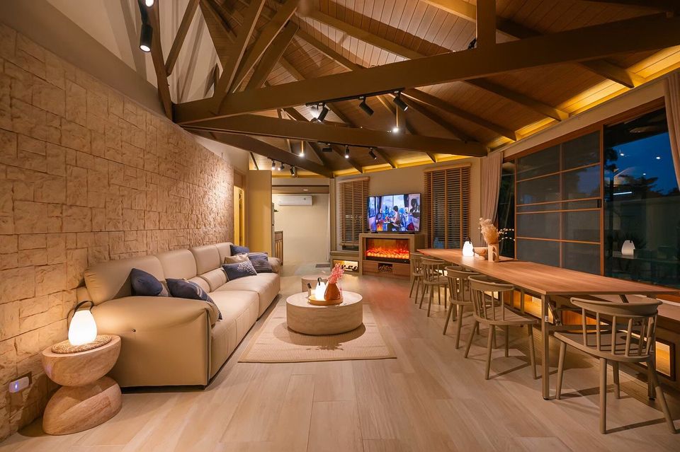 Spacious open-plan living and dining area with high wooden ceilings at Sand Moment VI Pool Villa, Rayong.