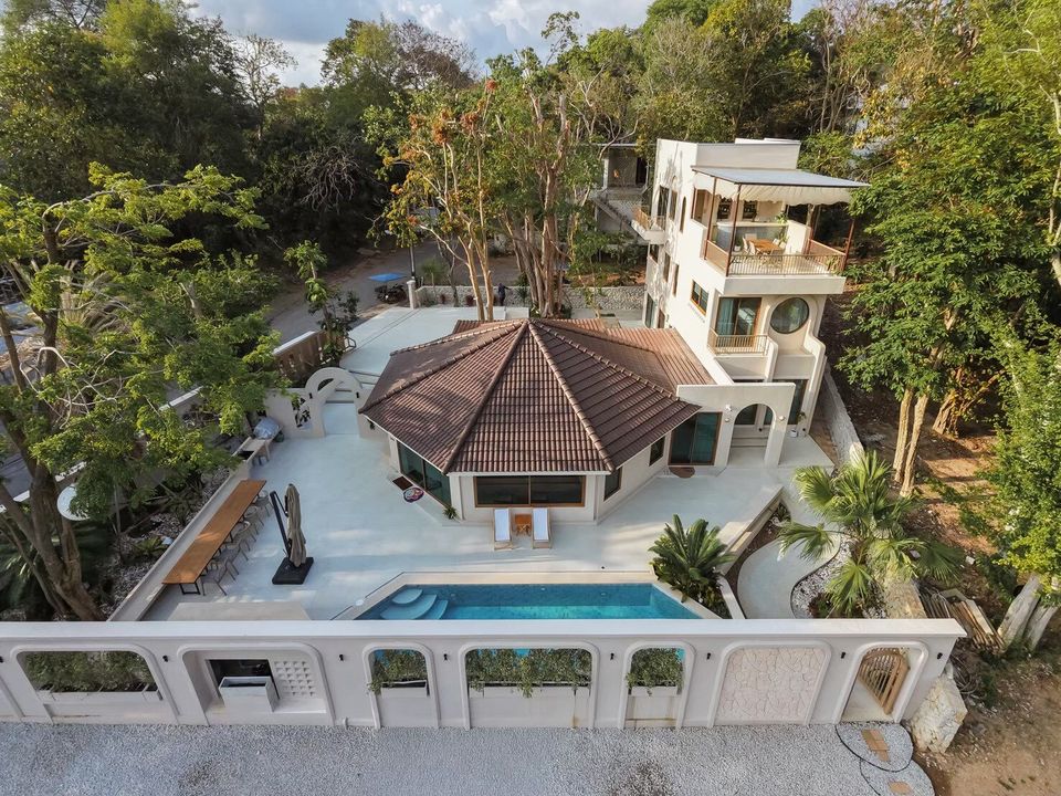 Aerial view of Sand Moment VI Pool Villa in Rayong, showcasing the entire property, pool, and surrounding lush greenery.