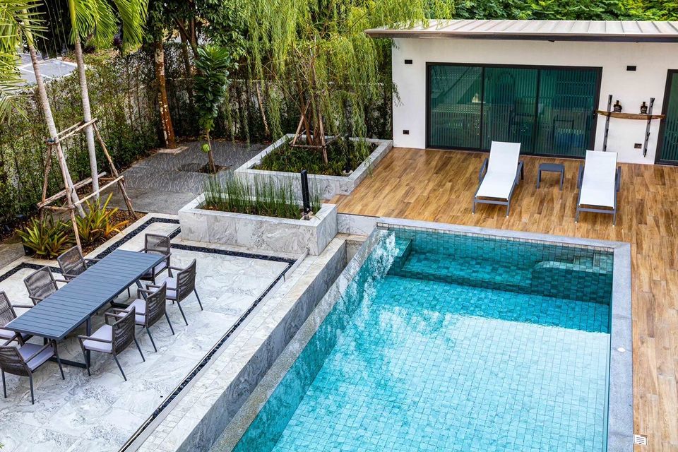 Aerial view of the pool, sun loungers, and outdoor dining area at Sea Moment IV Pool Villa, Rayong.
