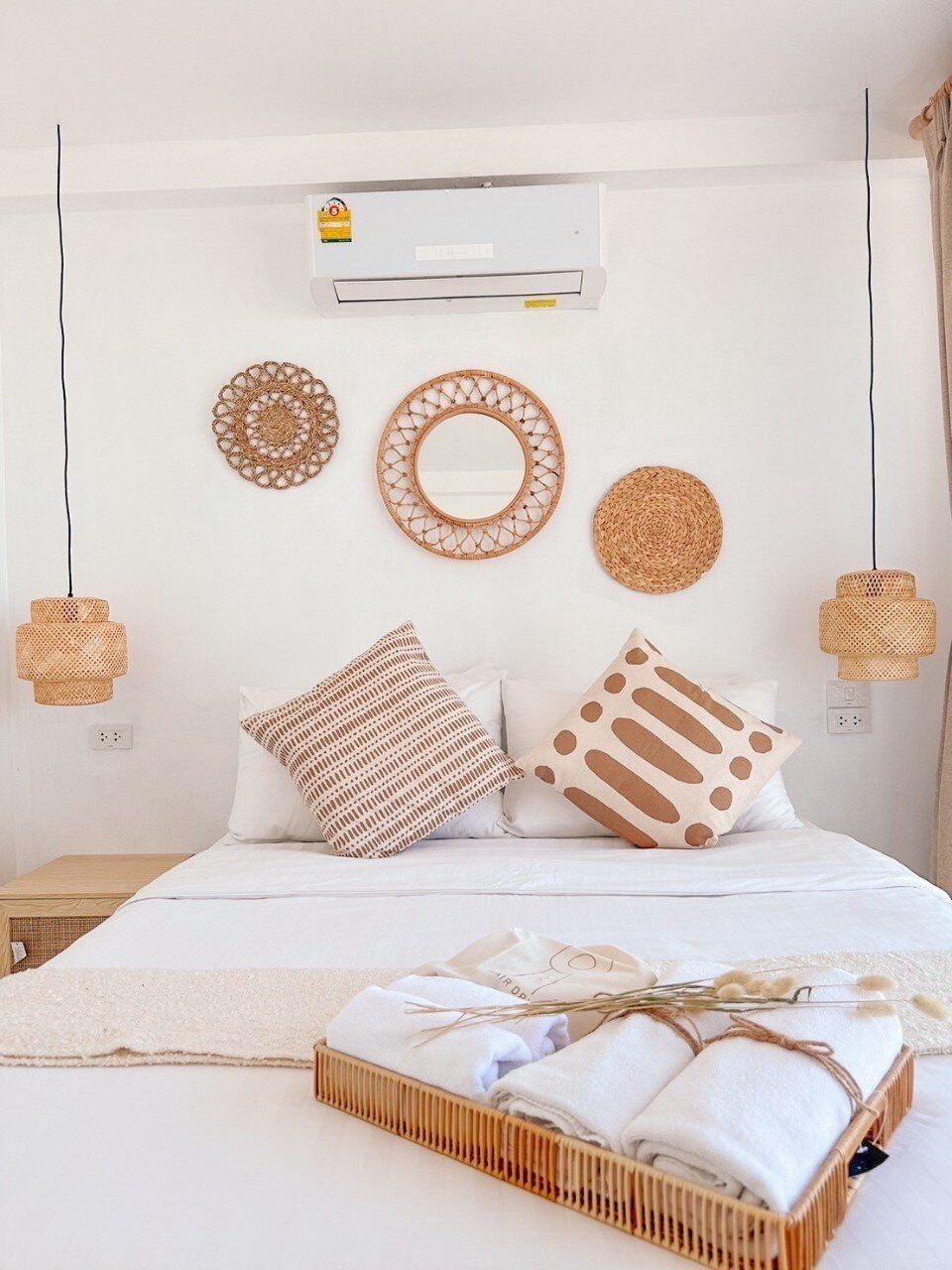 Bright bedroom with a king-size bed, white linens, and boho decor at Story II Pool Villa Hua-Hin.